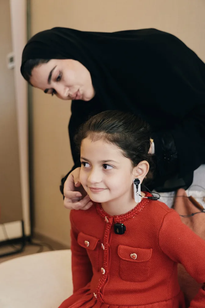 A clinician placing neurofeedback sensors for a child at MindTune